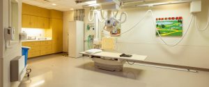 Seamless neutral commercial resilient flooring in a modern medical imaging room with healthcare equipment.