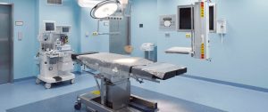 Seamless commercial vinyl sheet flooring with a flash cove base installed in a sterile hospital operating room by All Floors Commercial.