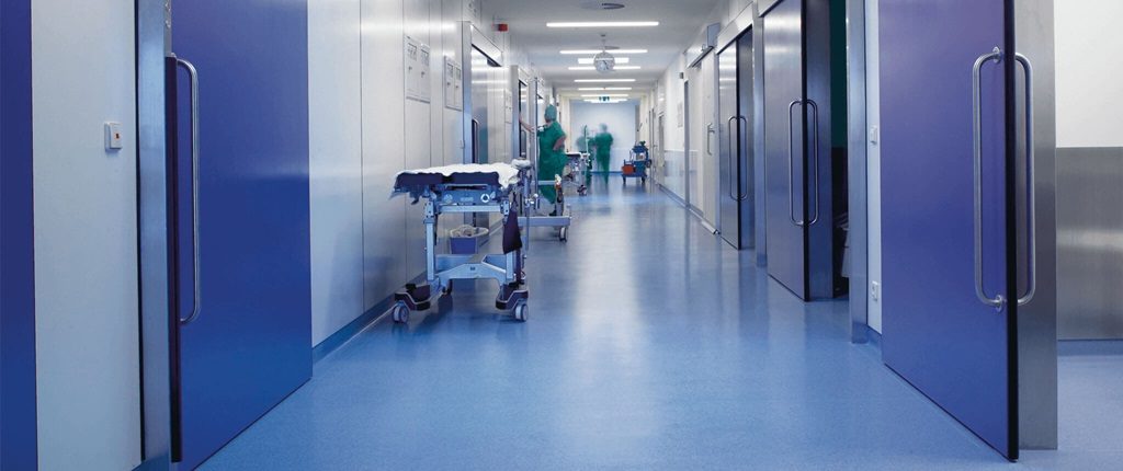A room in the hospital with hospital bed and a sofa. Hospital flooring by All Floor Commercial's. They provide commercial flooring across across Connecticut