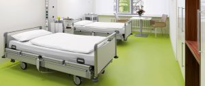 A room in the hospital with hospital bed and a sofa. Hospital flooring by All Floor Commercial's. They provide commercial flooring across across Connecticut
