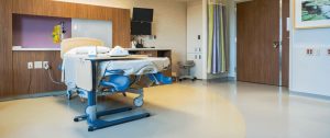 A room in the hospital with hospital bed and a sofa. Hospital flooring by All Floor Commercial's. They provide commercial flooring across across Connecticut