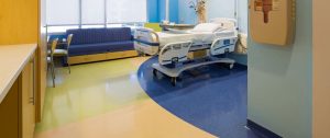 A room in the hospital with hospital bed and a sofa. Hospital flooring by All Floor Commercial's. They provide commercial flooring across across Connecticut